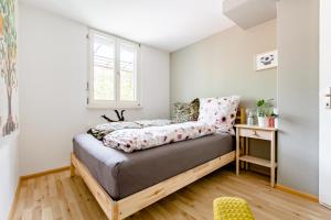 a bed in a room with a window at Do Well Messe in Basel