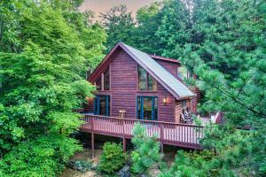 a wooden cabin in the middle of a forest at NEW HOT TUB! Secluded 3 Bed Cabin in Pigeon Forge in Pigeon Forge