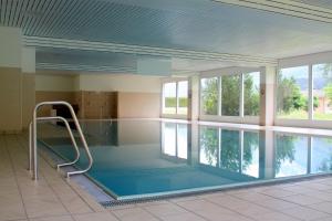 a large indoor swimming pool in a building at Apartment Scuol in Scuol