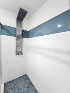 a bathroom with white walls and a control panel at Heated pool just 1.7 mi to beach The Ocean Pearl in Sarasota