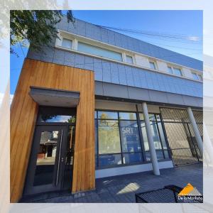 an external view of a building with a revolving door at De La Montaña - Loft in Esquel