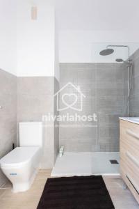 uma casa de banho com um WC branco e um lavatório. em The Happy Place Santa Cruz, by Nivariahost em Santa Cruz de Tenerife