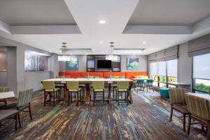 a dining room with a large table and chairs at Hampton Inn Iowa City/Coralville in Coralville