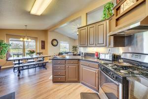 a kitchen with a stove and a dining room at Lincoln Vacation Rental with Private Fire Pit! in Lincoln
