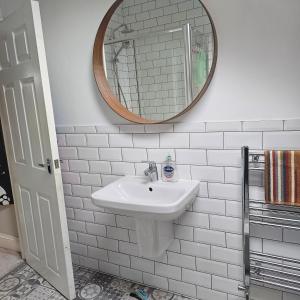 a white bathroom with a sink and a mirror at Shrewsbury 1 in Manchester