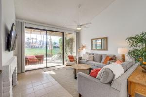 a living room with a couch and a fireplace at Palm Desert Condo with Patio and Golf Course Views in Palm Desert