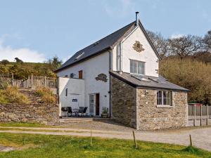 a white building with a black roof at 3 Bed in Conwy 74146 in Eglwys-Fâch