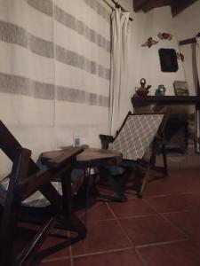 a room with a table and two chairs and a piano at Cabañas "Rancho La Mesa" in Pátzcuaro