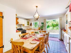 a kitchen and dining room with a wooden table and chairs at 2 Bed in Sway NFL43 in Sway