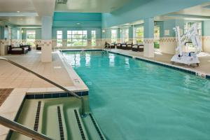 a large indoor swimming pool in a building at Residence Inn Dulles Airport At Dulles 28 Centre in Sterling