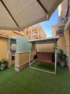 an outdoor patio with a gazebo on a balcony at DownTown New Cairo in Cairo