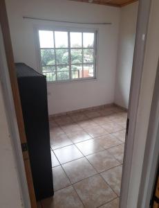 an empty room with a window and a tile floor at Residencial GM in San Vicente