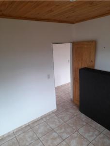 an empty room with a door and a television at Residencial GM in San Vicente