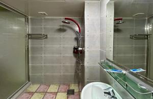 a bathroom with a shower with a toilet and a sink at Two motel in Tongyeong