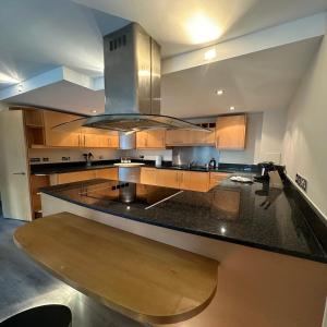 a large kitchen with a large island with a stove at Canary Wharf Apartments in London