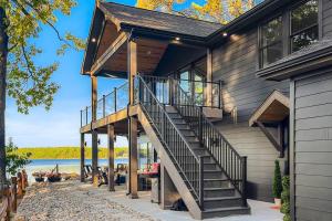a house with a staircase on the side of it at Leo's Bear Lake Hideaway in Kalkaska