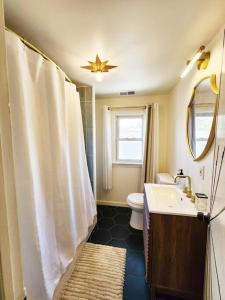 y baño con ducha, aseo y lavamanos. en Chic Spacious Apt Near Attractions/Food/EWR/NYC, en West Orange