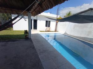 a swimming pool in the backyard of a house at CASA PARLAMAR in Monterrico