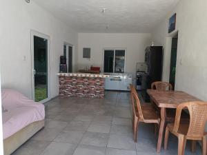 a kitchen and dining room with a table and a fireplace at CASA PARLAMAR in Monterrico