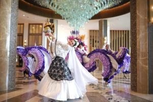 a group of people dancing in a room at Fili Hotel at Nustar Cebu in Cebu City