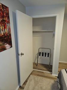 a room with a bedroom with a walk in closet at Cozy and quiet apartment in Sudbury