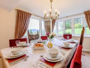 a dining room with a table with chairs and a large window at 4 Bed in Symonds Yat 79373 in Goodrich