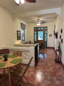 a living room with a fireplace and a table and chairs at Spa Apartment in Mayaguez