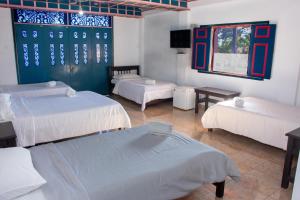 Voodi või voodid majutusasutuse Hotel Karlaká Calarcá Quindio - Eje Cafetero toas