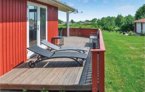 a wooden deck with two benches on a house at Holiday Home Fiskervej Sydals Xii in Skovby