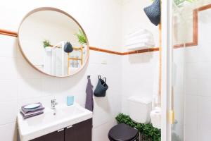 a bathroom with a sink and a mirror at Live in the heart of Surry Hills - walk to City in Sydney