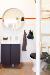 a bathroom with a black toilet and a mirror at Live in the heart of Surry Hills - walk to City in Sydney
