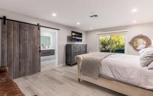 a bedroom with a large bed and a mirror at Desert Oasis Retreat Luxe Hideaway in Paradise Valley in Scottsdale