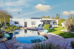 a house with a swimming pool in the yard at Desert Oasis Retreat Luxe Hideaway in Paradise Valley in Scottsdale