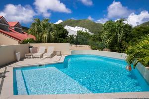 a swimming pool in the backyard of a house at Beautiful suite S12 with pool and sea view in Cul de Sac