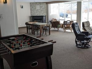 a living room with a pool table and chairs at Bienvenue chez Alice et daniel in Saint-Férréol-les-Neiges