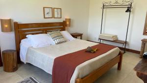 a bedroom with a large bed with at Pousada Sete Quedas in Carrancas