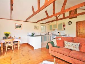 a living room with a couch and a kitchen at 1 bed in Looe NUTHA in Warleggan