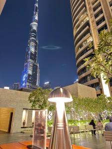 a lamp sitting on a table in front of a building at Emaar Residences Fashion Avenue - Formerly Address Dubai Mall in Dubai