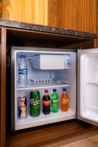 an open refrigerator filled with drinks and soda at Kailash Boutique Hotel in Kathmandu