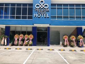 a building with a bunch of flowers in front of it at The Clover Hotel in Angeles