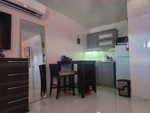 a kitchen with a table and chairs in a room at Vadi's Lux, Wi-fi, coffe, tea, parking, laundry room. in Mayaguez