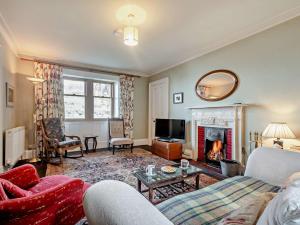 a living room with a couch and a fireplace at 2 Bed in Lochranza 77882 in Lochranza