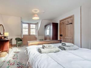 a bedroom with a large bed with towels on it at 2 Bed in Lochranza 77882 in Lochranza