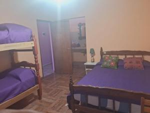 a bedroom with two bunk beds and a mirror at Casa Mamani in Tilcara