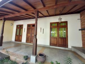 an image of a house with wooden doors at Cosy Secure Comfortable for whole family in Colombo