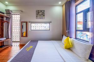 Postel nebo postele na pokoji v ubytování Richy Dalat Hotel