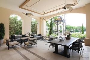 a living room with tables and chairs and a patio at 20min to City Bloomsbury Ramintra Luxury Family Big House in Bang Khen