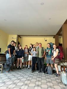 a group of people posing for a picture in a room at Vang Vieng Global Hostel in Vang Vieng