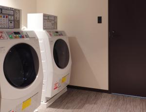 神戶的住宿－Hotel SUI Kobe Sannomiya by ABEST，隔壁房间设有两台洗衣机
