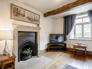 a living room with a fireplace and a couch at 3 Bed in Hartington 54215 in Hartington